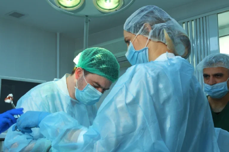Surgeons operating in theatre